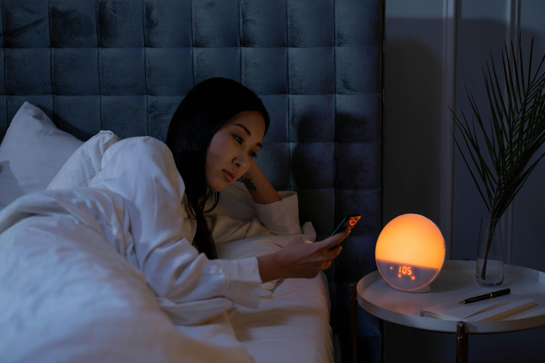 Woman lying awake at night experiencing menopause-related insomnia — why sleep may get harder after 40